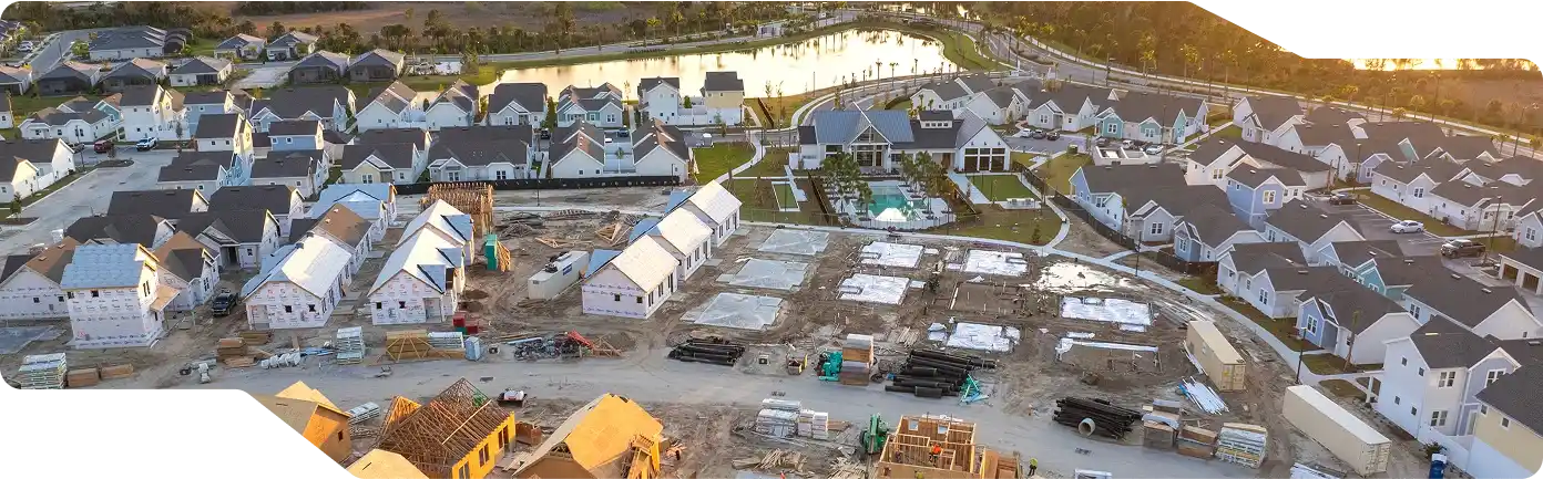 Overhead perspective of a neighborhood in McAllen, highlighting multiple houses in various stages of construction. multifamily buildings