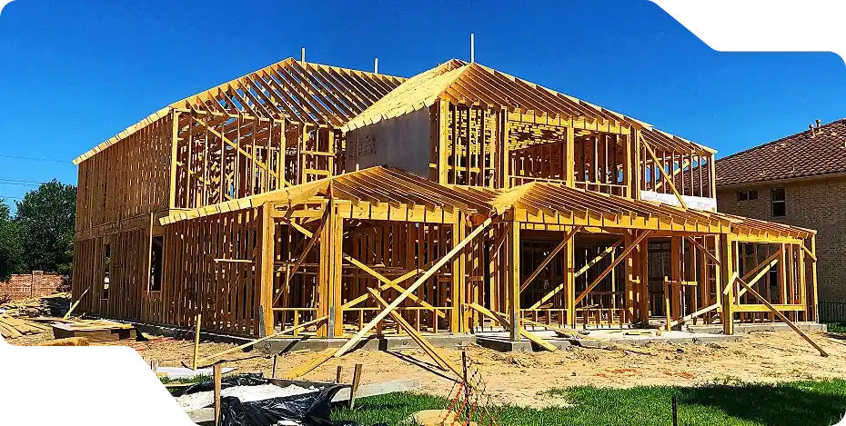 Wooden framing of a house under construction, representing custom building in McAllen.