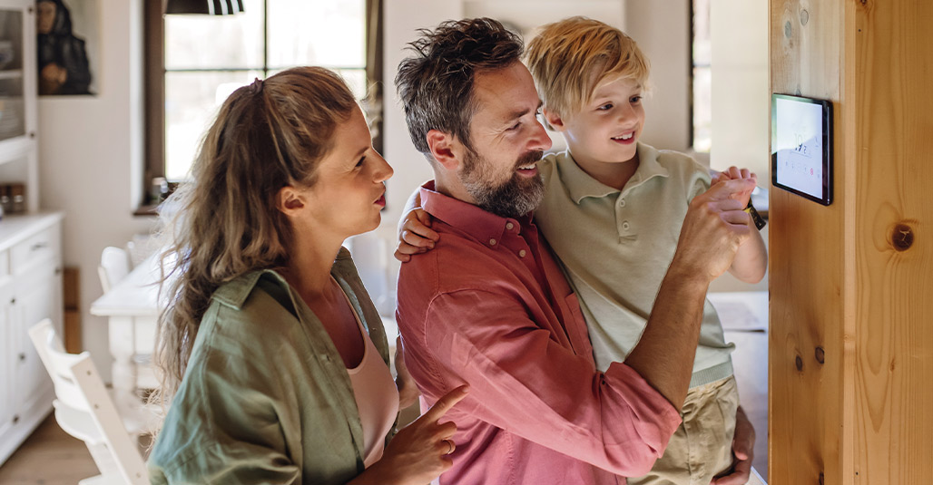  family engages with a smart TV, discussing energy-efficient home upgrades that benefit the RGV.