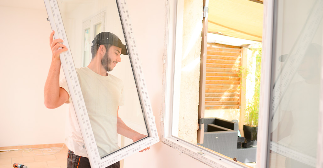 A man holding a window, reflecting on energy-efficient home upgrades in the RGV.